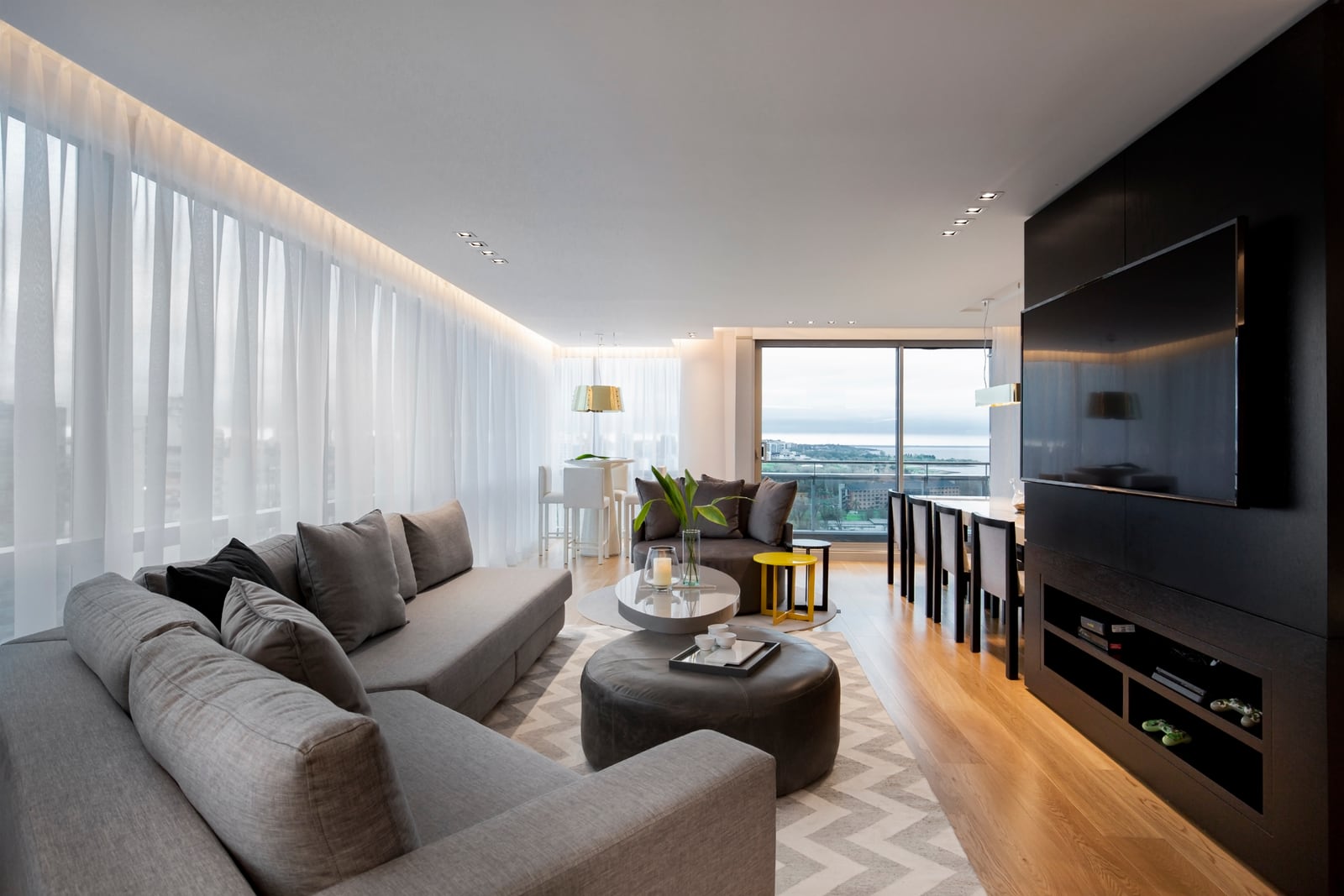 Vicente López al Río I, living con sofá modular gris y vista al río